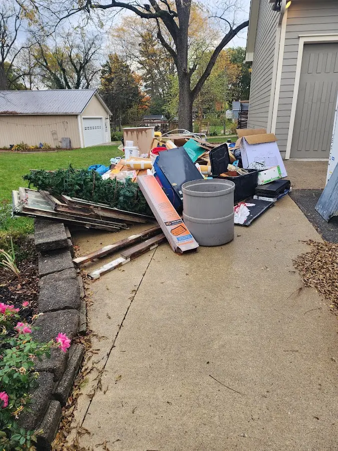 Dumpster being loaded with debris for Roofing Dumpster Rental in Wilna